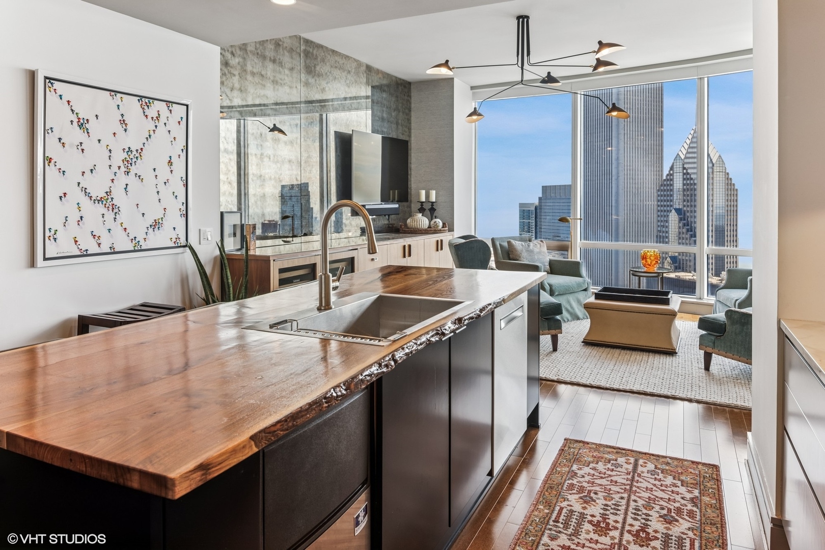 401 North Wabash Avenue, Unit 54E Chicago, IL 60611 - Photo 10 of 29 a kitchen with a sink a stove and chairs