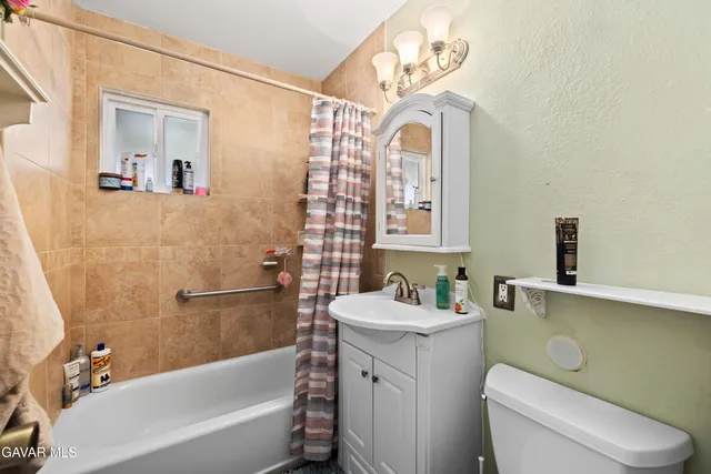 a bathroom with a sink a toilet and bathtub