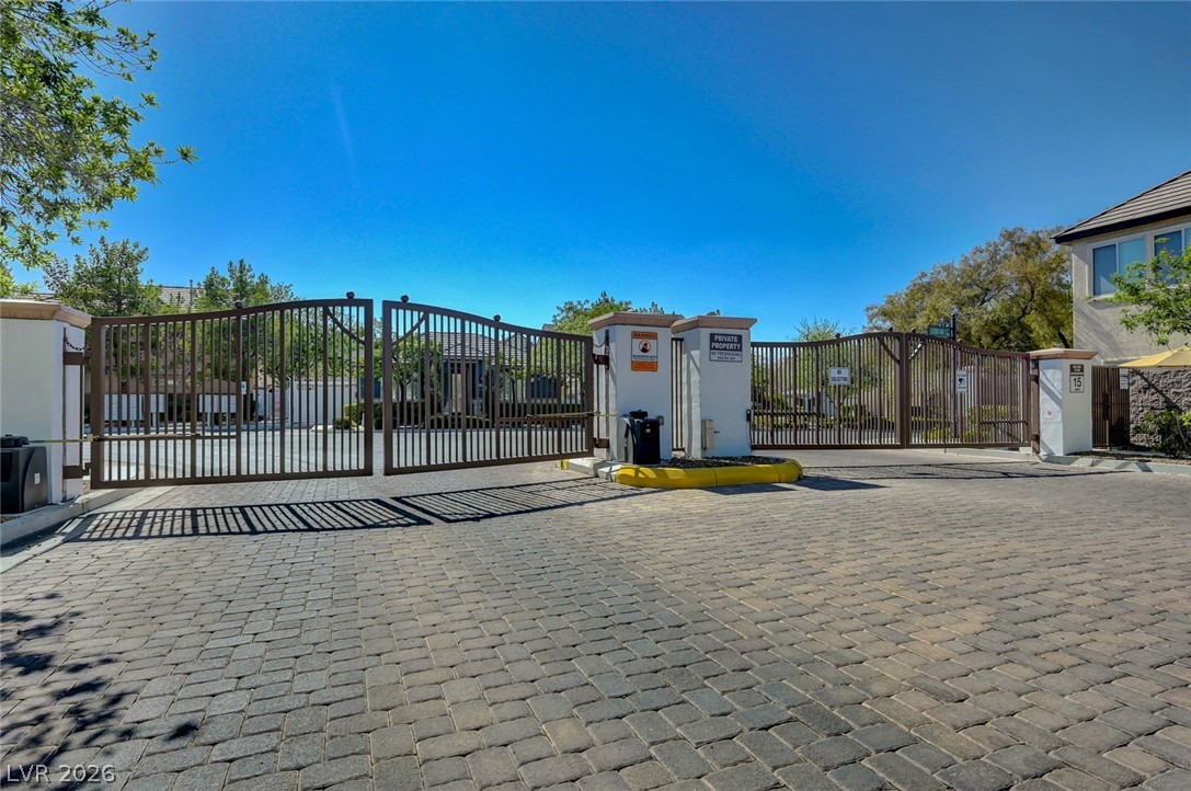 977 Sparkling Light Street Henderson, NV 89052 - Photo 67 of 75 Secure community entrance with an elegant wrought iron gate and paver driveway.