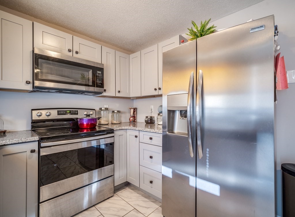 170 Walnut Street Springfield, MA 01105 - Photo 8 of 17 a kitchen with cabinets stainless steel appliances and a sink