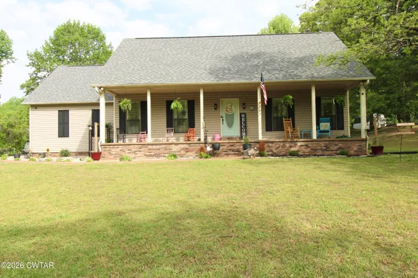 a front view of house with outdoor seating and yard