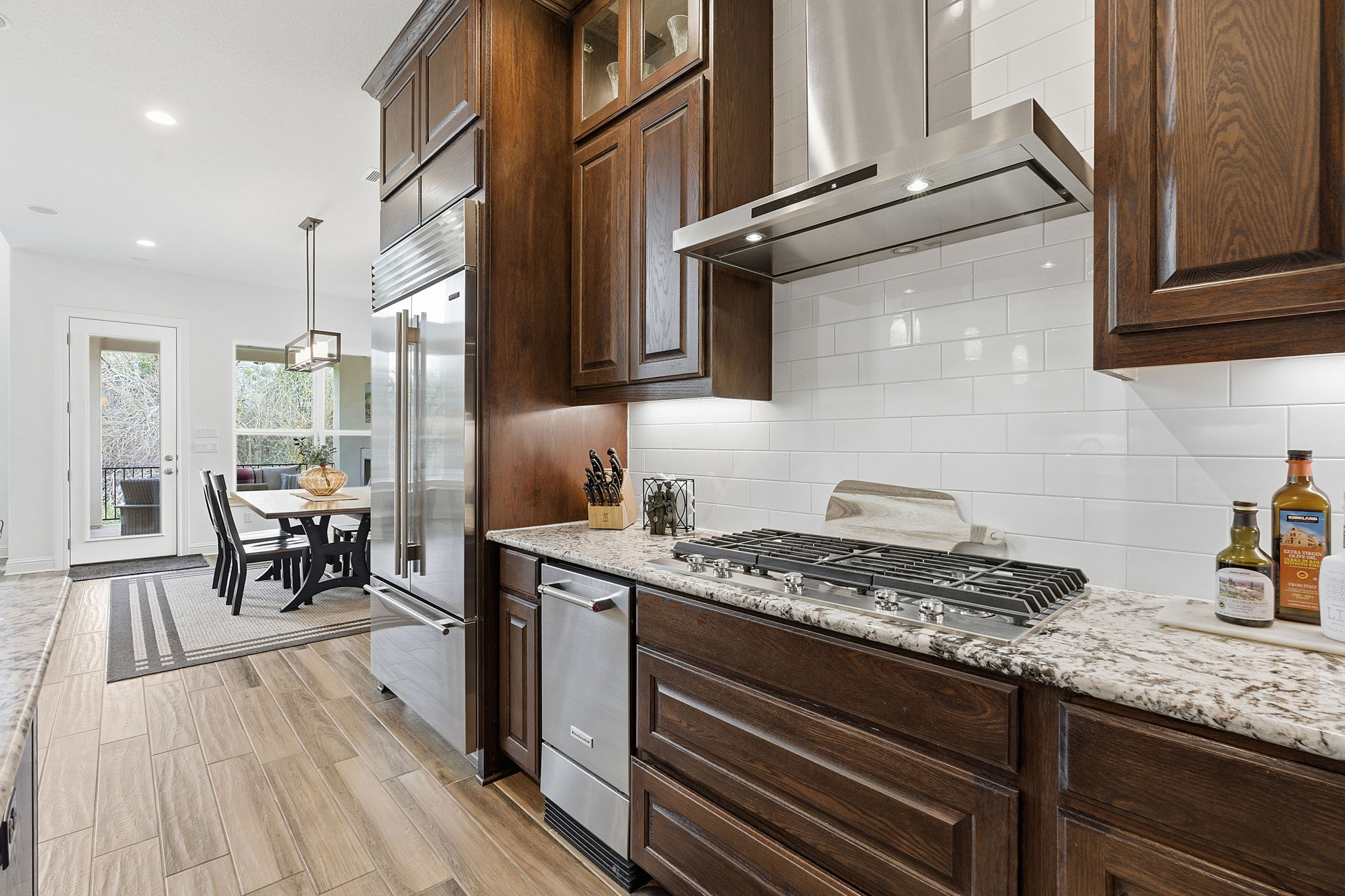 2824 Wedgescale Pass Leander, TX 78641 - Photo 14 of 40 Stainless steel appliances include a 5-burner gas cooktop with hooded exterior ventilation