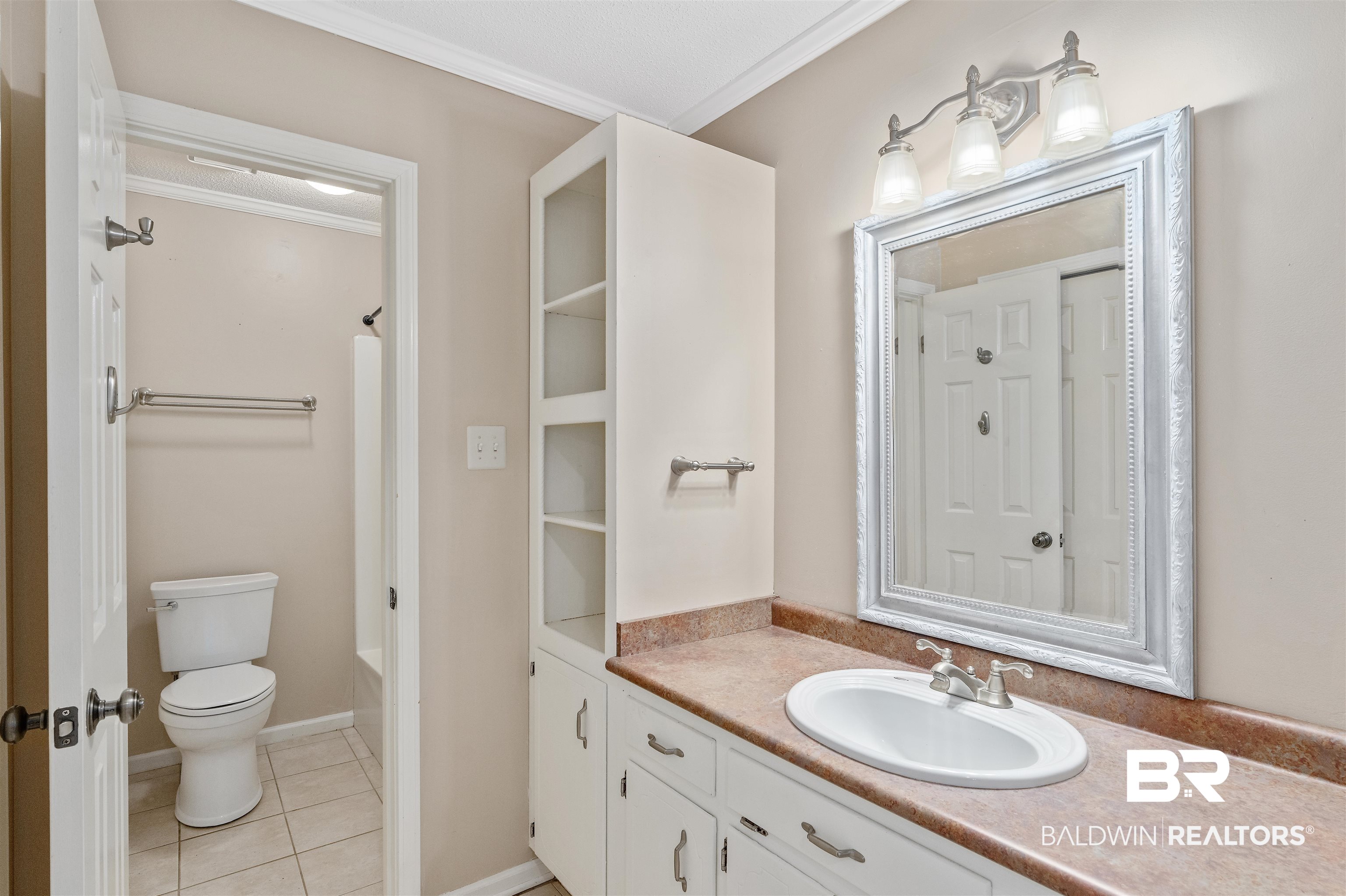 25779 Austin Road Daphne, AL 36526 - Photo 25 of 30 Full bathroom with vanity, toilet, tile patterned flooring, washtub / shower combination, and crown molding