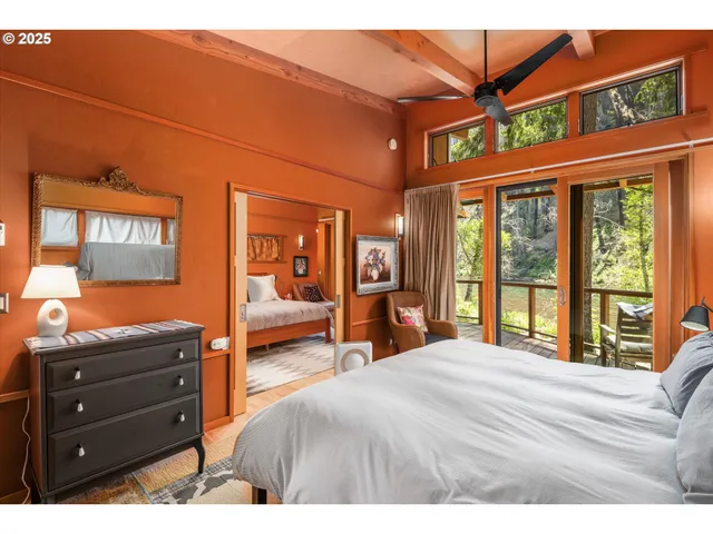 a bedroom with a large bed and a chandelier