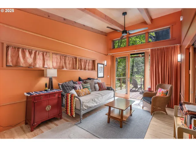 a living room with furniture a ceiling fan and a window