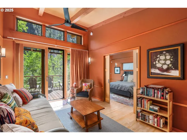 a living room with furniture a rug and a large window