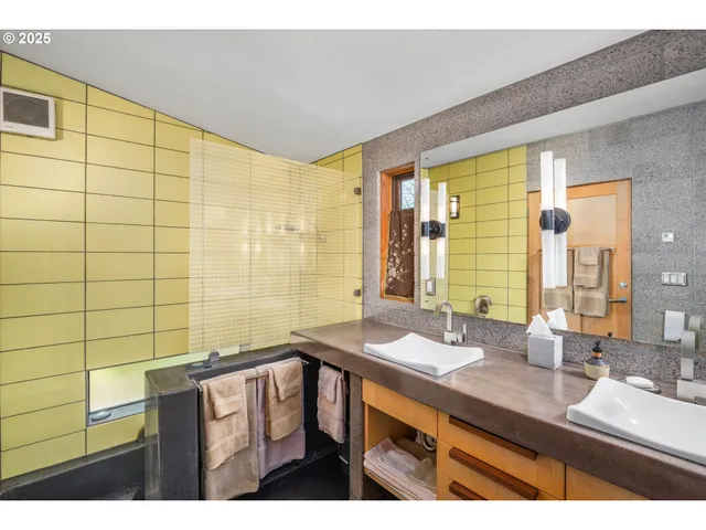 a bathroom with a double vanity sink and a mirror