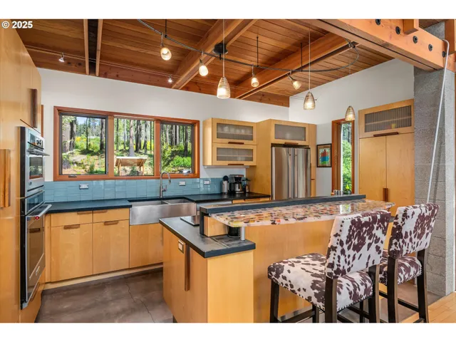 a kitchen with stainless steel appliances granite countertop a sink and cabinets