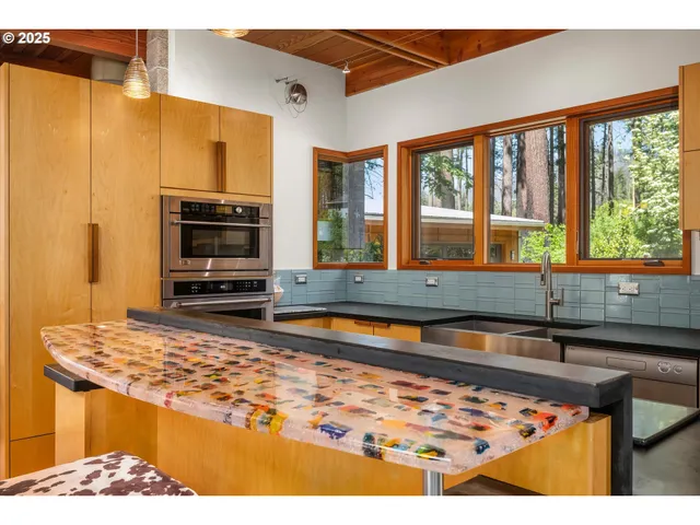a kitchen with a stove and a wooden floor