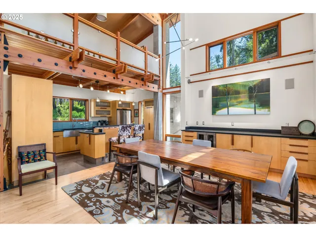 a dining room with furniture and a floor to ceiling window