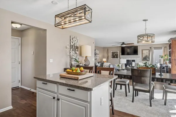 a view of a dining room and livingroom with furniture wooden floor a chandelier