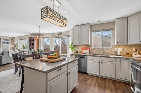 a kitchen with stainless steel appliances granite countertop a sink and cabinets
