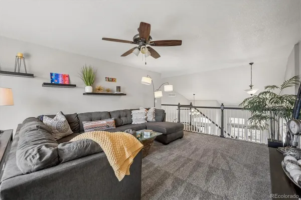 a living room with furniture and a potted plant