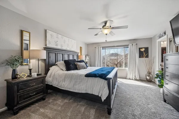 a bedroom with a bed and a chandelier