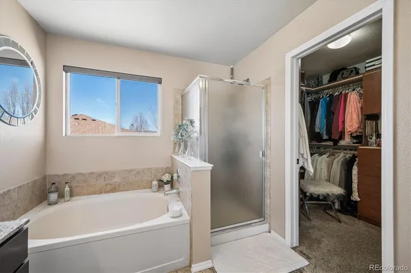 a bathroom with a tub and a shower