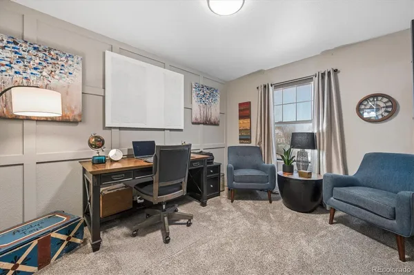 a view of a workspace with furniture and a window