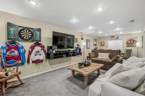 a living room with furniture a flat screen tv and rug