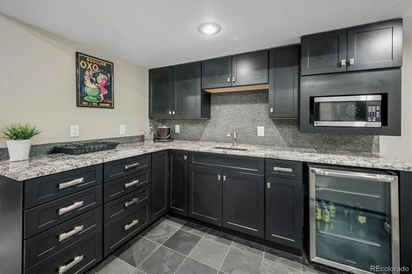 a kitchen with stainless steel appliances granite countertop a sink and a granite counter tops