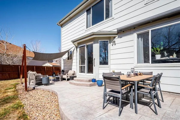 a patio with a table and chairs