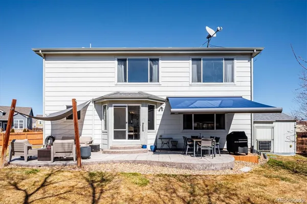 a view of a house with outdoor seating space