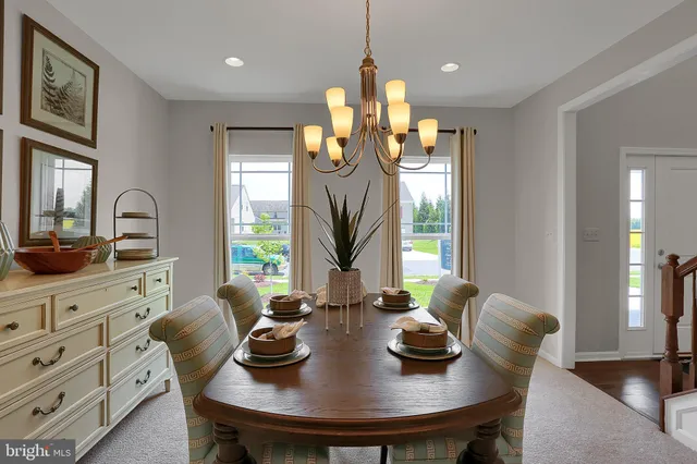 a view of a dining room with furniture and window