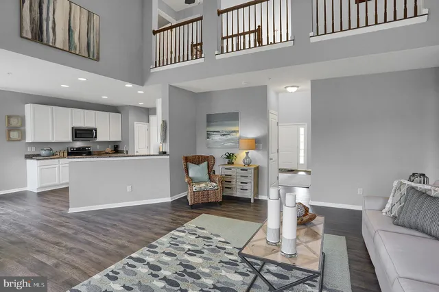 a living room with furniture and kitchen view