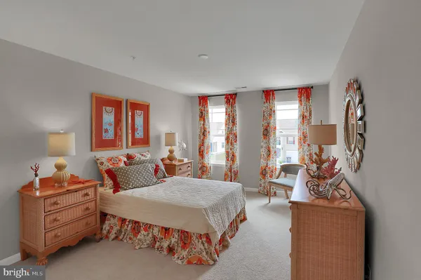 a bedroom with a bed and large windows