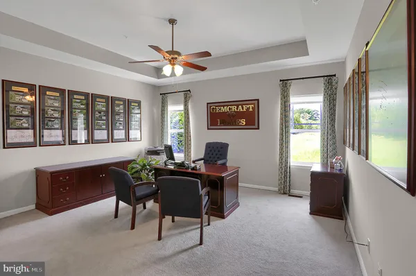 a view of a workspace with furniture and a window