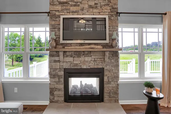a living room with a fireplace and windows