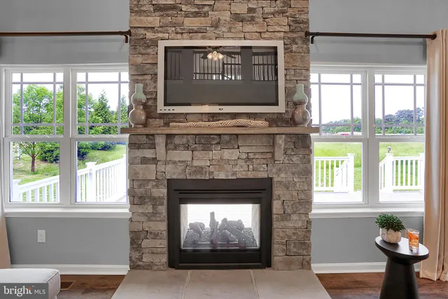 a living room with a fireplace and windows