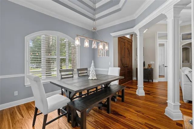 a bedroom with a bed a flat screen tv and dresser