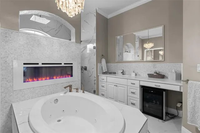 a living room with furniture kitchen view and a chandelier