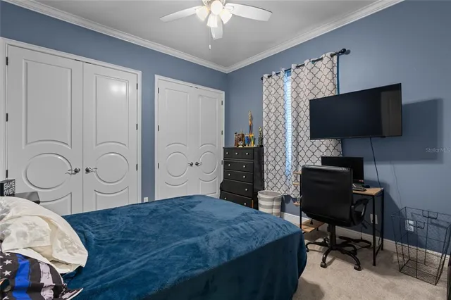 an aerial view of residential houses with outdoor space and a swimming pool