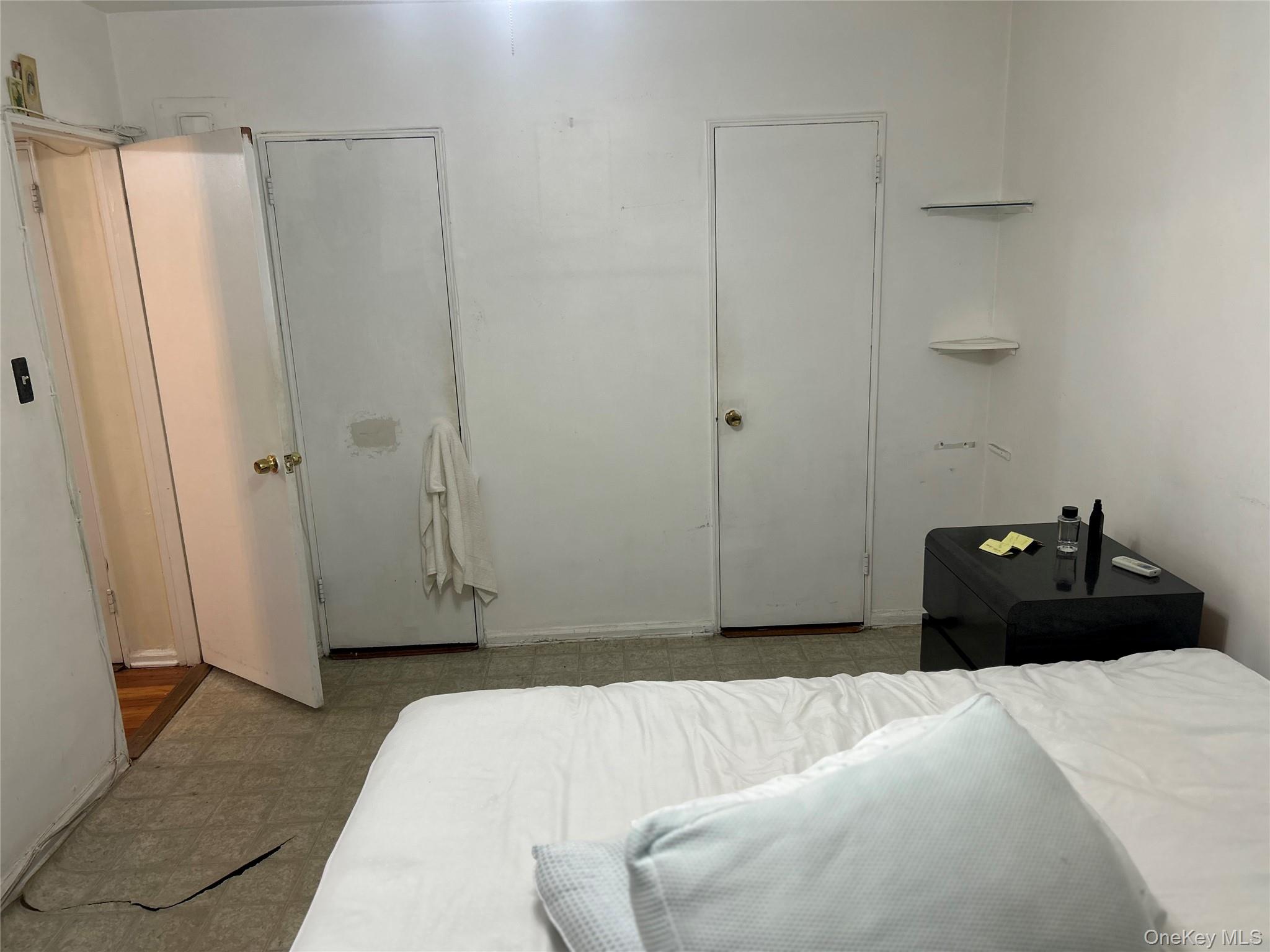 83-20 98th Street, Unit 5J Queens, NY 11421 - Photo 12 of 17 a bedroom with a bed and a shower