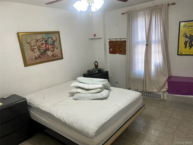 a bedroom with a bed and window
