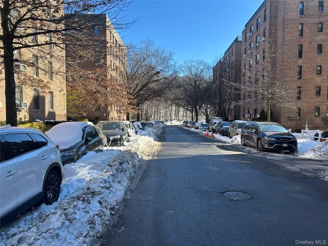 a row of cars parked on the side of a street