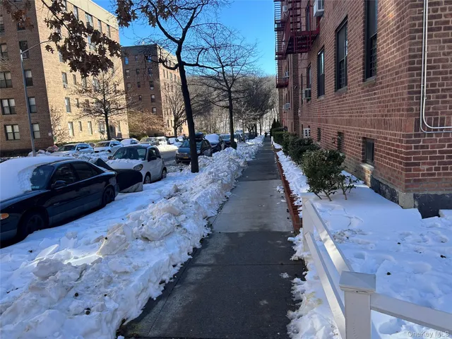 a view of a street with cars parked