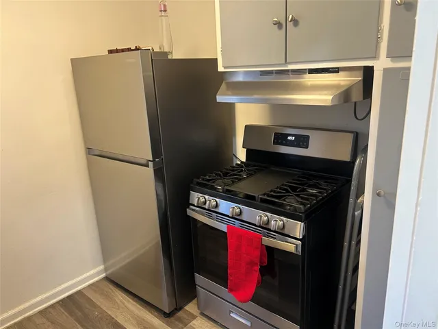 a stove top oven sitting inside of a kitchen