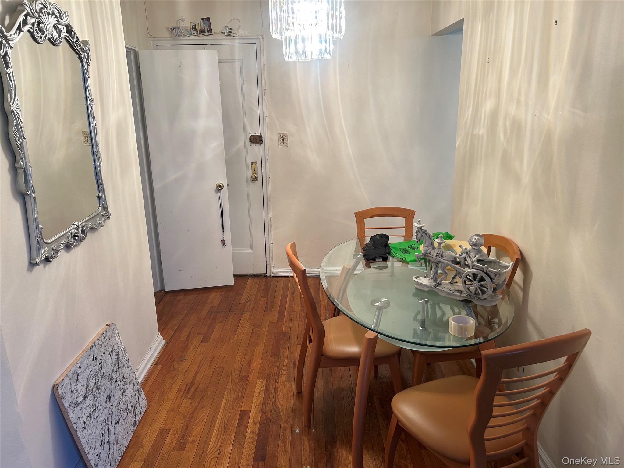 83-20 98th Street, Unit 5J Queens, NY 11421 - Photo 10 of 17 a dining room with furniture and wooden floor