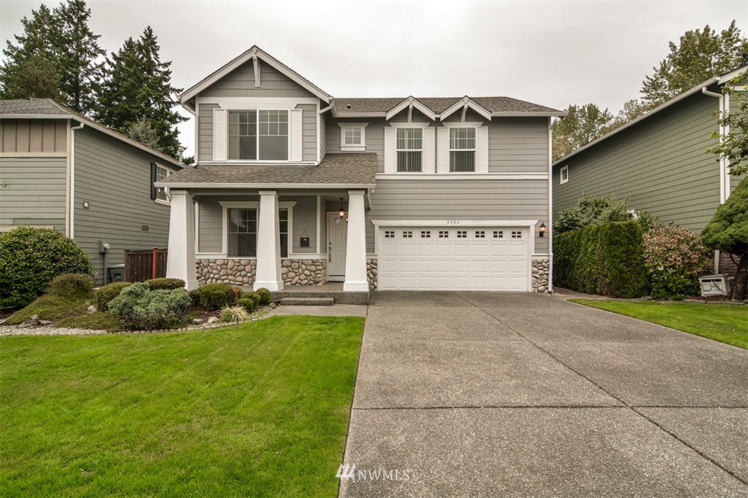 2402 Southeast 2nd Place Renton, WA 98056 - Photo 2 of 40 a front view of a house with a yard and garage