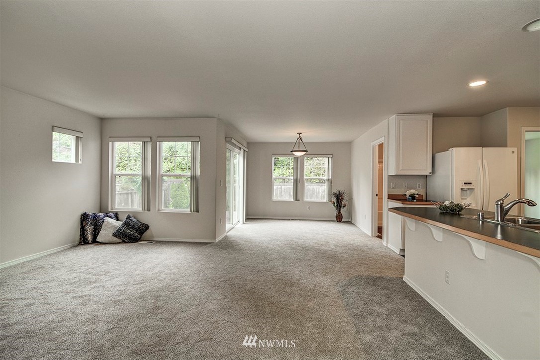 2402 Southeast 2nd Place Renton, WA 98056 - Photo 11 of 40 a large bedroom with a bed a couch and a window