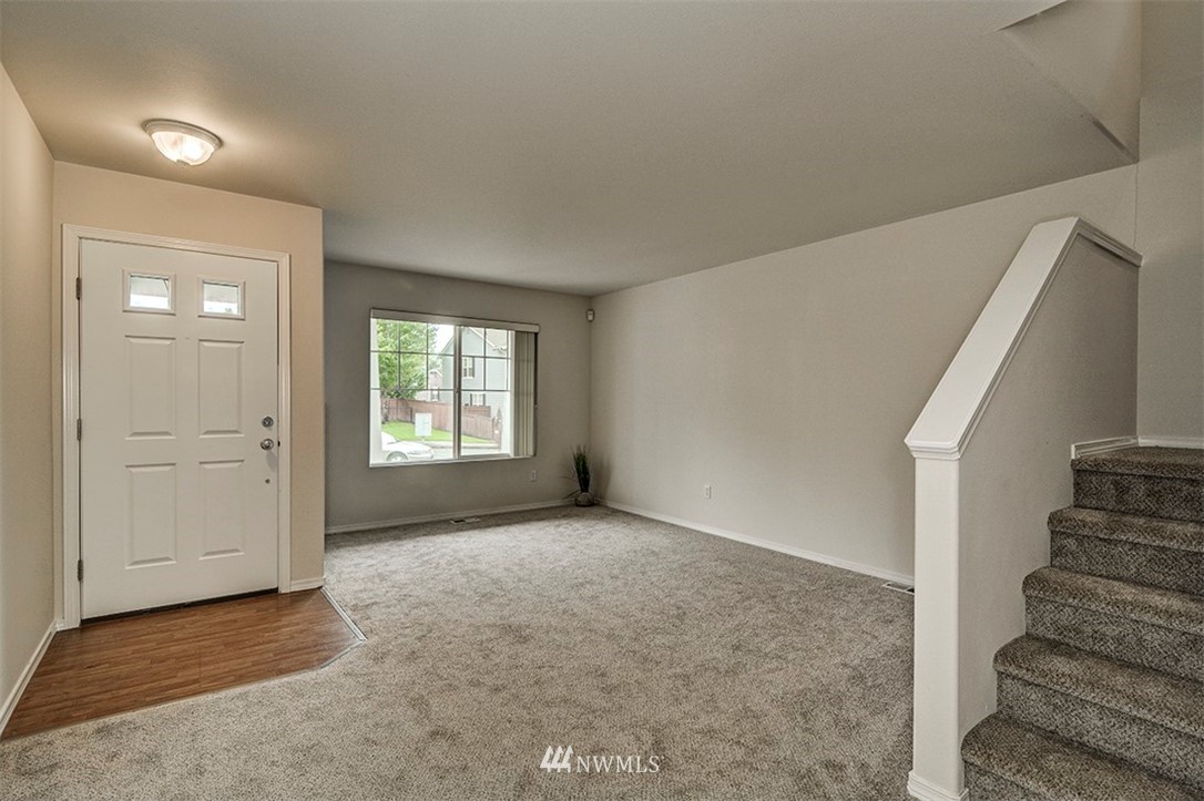 2402 Southeast 2nd Place Renton, WA 98056 - Photo 15 of 40 a view of an empty room with stairs and a window