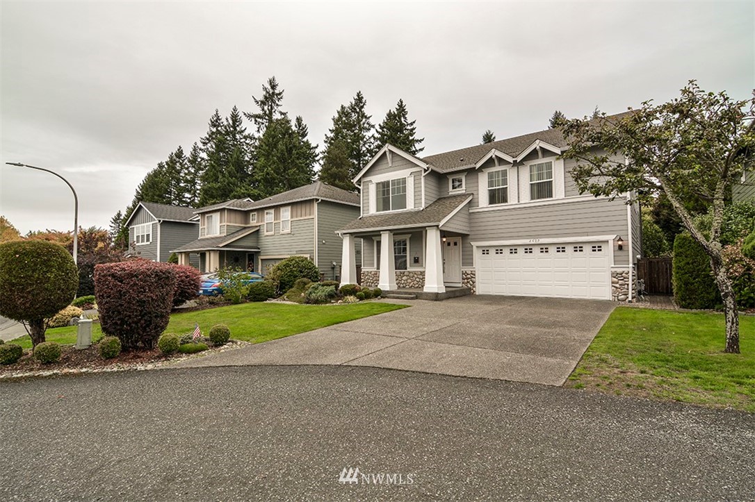2402 Southeast 2nd Place Renton, WA 98056 - Photo 3 of 40 a front view of a house with a yard and garage