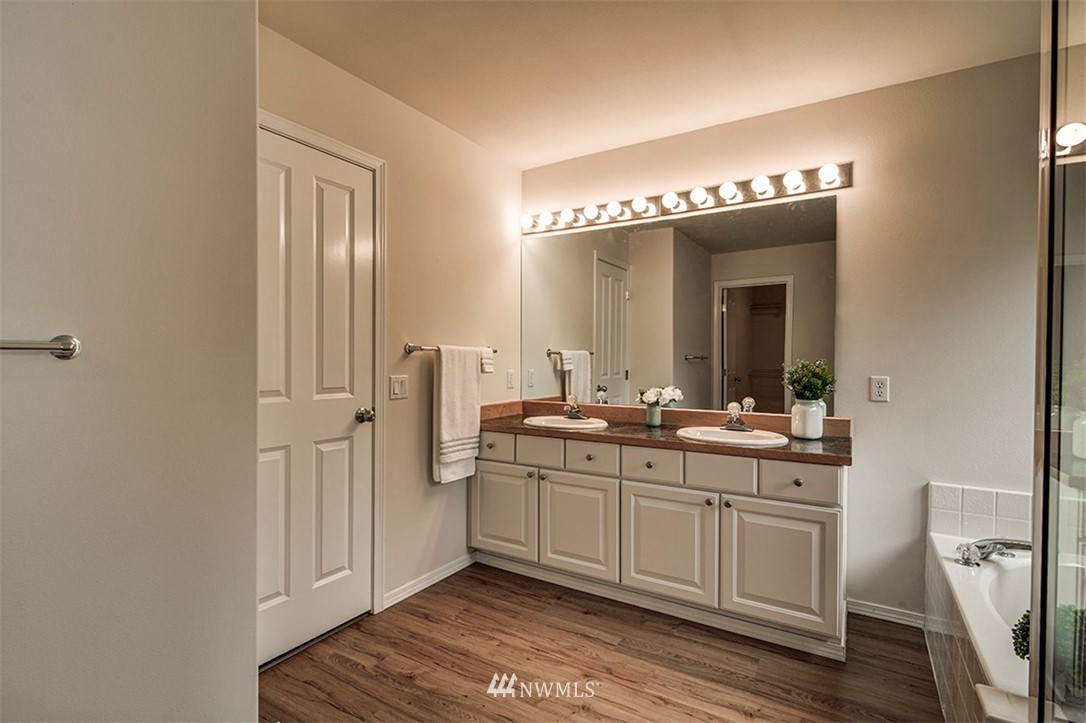 2402 Southeast 2nd Place Renton, WA 98056 - Photo 26 of 40 a spacious bathroom with a double vanity sink and a mirror