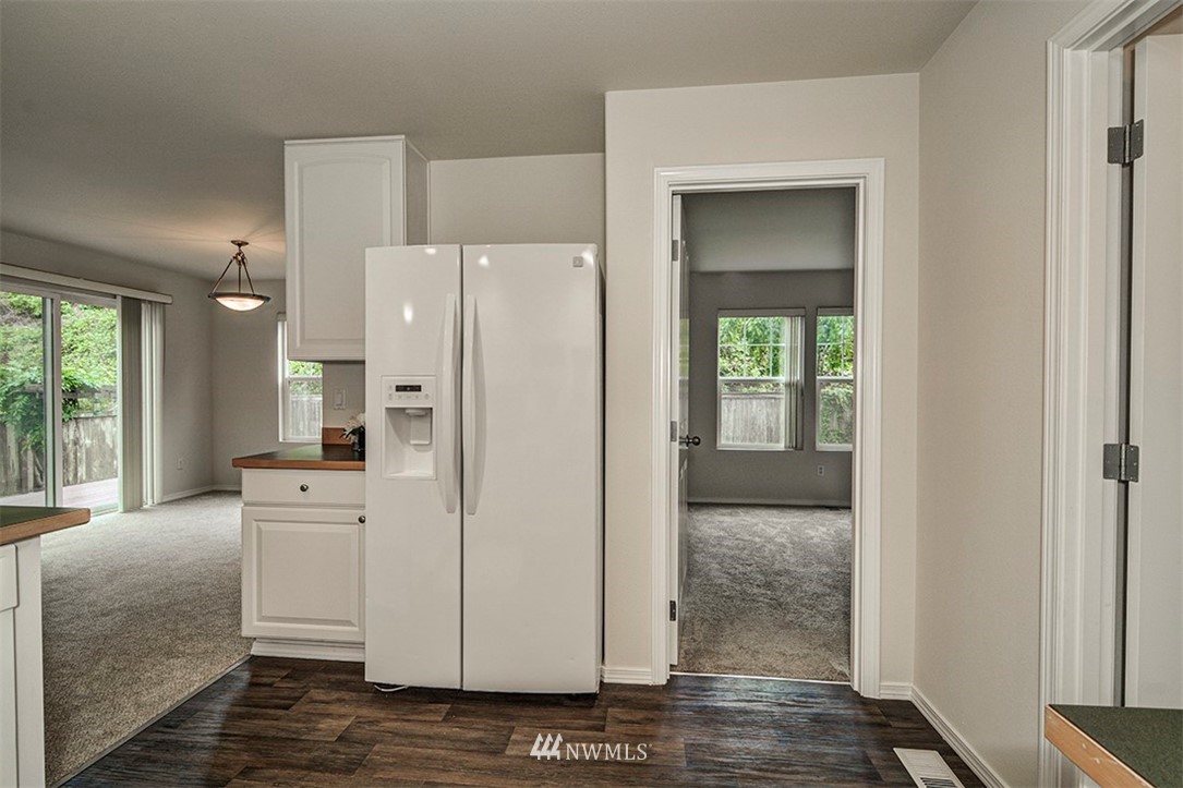 2402 Southeast 2nd Place Renton, WA 98056 - Photo 7 of 40 a view of a kitchen with refrigerator and wooden floor