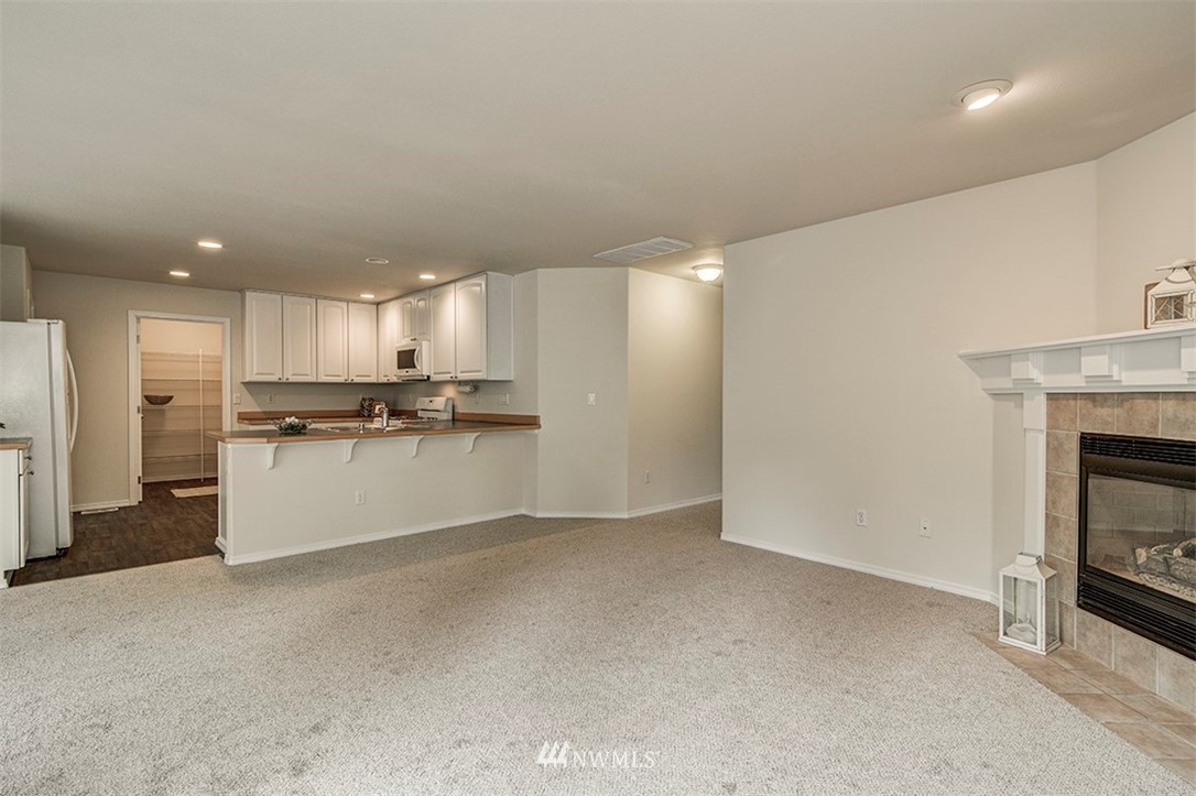 2402 Southeast 2nd Place Renton, WA 98056 - Photo 10 of 40 a view of kitchen with kitchen island wooden cabinets and refrigerator