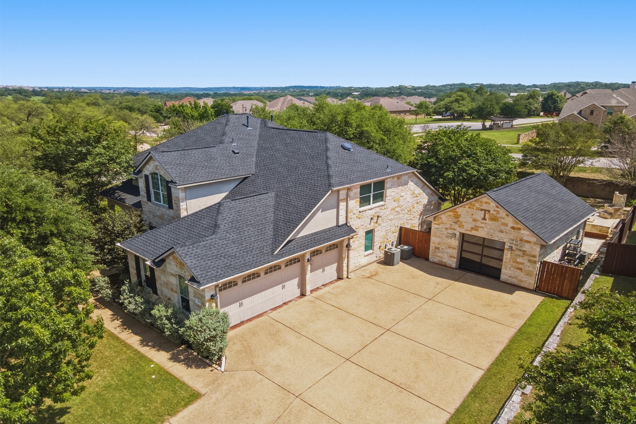 1023 Grassy Field Road Austin, TX 78737 - Photo 37 of 40 Aerial perspective showing 3300+ sq ft residence and 480 sq ft fully finished detached garage surrounded by mature trees.