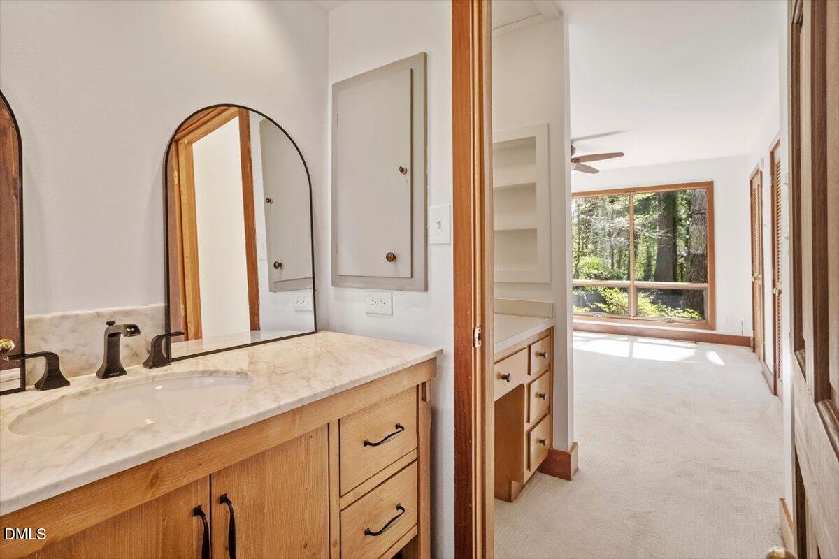 4805 Rembert Drive Raleigh, NC 27612 - Photo 26 of 45 a spacious bathroom with a granite countertop sink a mirror a vanity and a bathtub