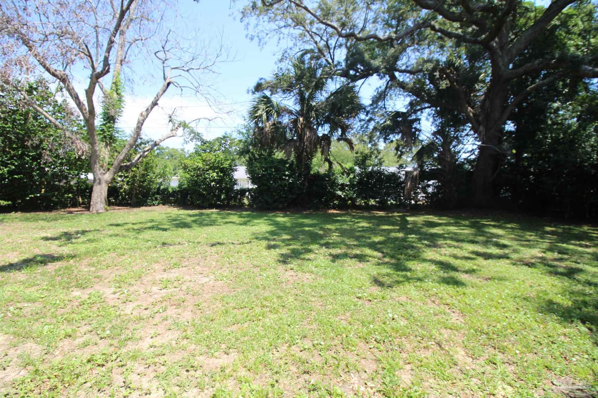 315 Flannan Road Pensacola, FL 32507 - Photo 17 of 17 a view of green field with trees in the background