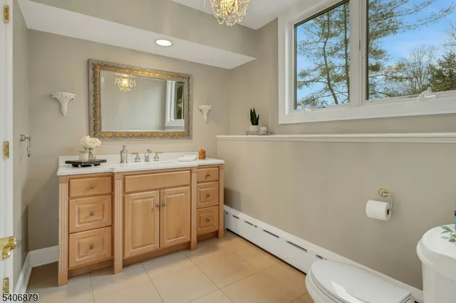 a bathroom with a granite countertop toilet sink and mirror